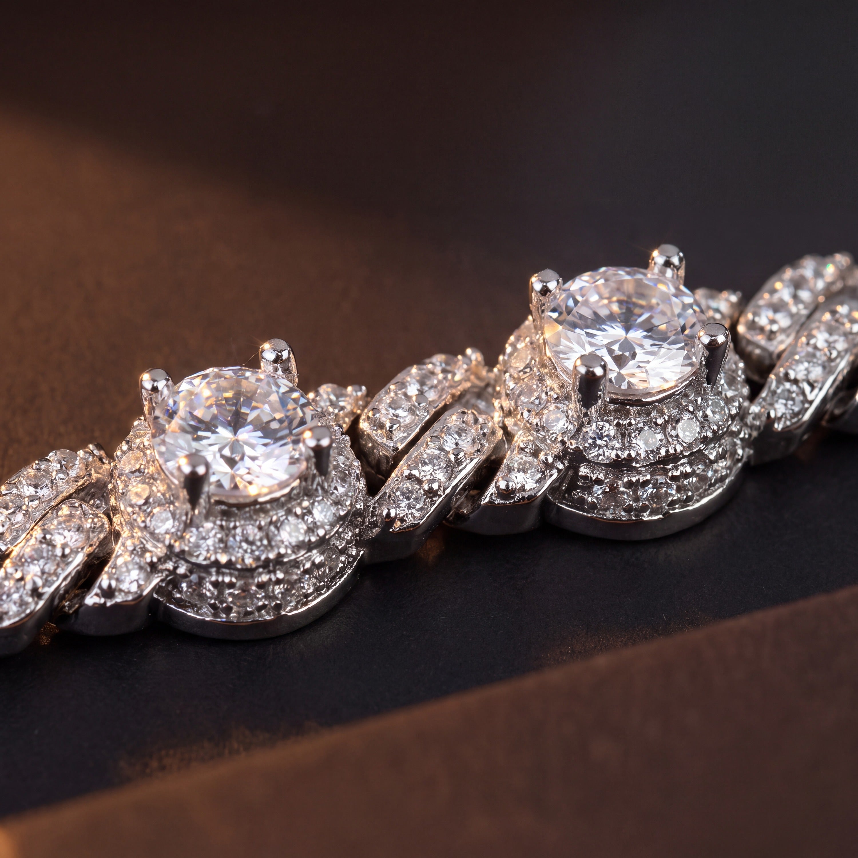 Close-up of the four-prong halo stations and pave Cuban links on a station bracelet